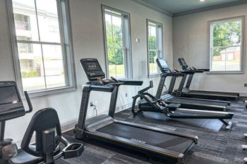 a row of treadmills in a gym with windows at Quail Ridge Apartment Homes, TN, 38135